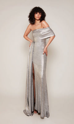 A person wears the silver Alyce 27663 long formal dress, featuring a metallic jacquard design, off-the-shoulder neckline, and thigh-high side slit, standing against a plain background.