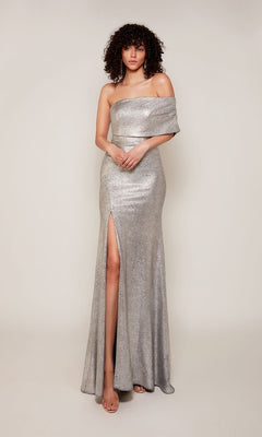 A woman models the Alyce 27663, a silver metallic jacquard long formal dress featuring a floor-length skirt and thigh-high side slit, set against a plain light background.