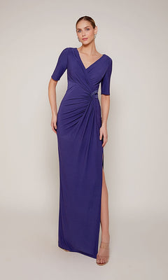 A woman stands against a plain background wearing the Alyce 27682 long formal dress, featuring short sleeves, a v-neckline, floor-length design, and side slit.