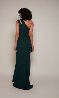 A person wearing the Alyce 27689 long formal dress in dark green, with a one-shoulder design, stands facing away from the camera against a plain background.