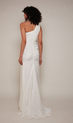 Person wearing the Alyce 27697 long formal dress—a white, one-shoulder satin gown with ruched detailing—photographed from the back against a plain background.