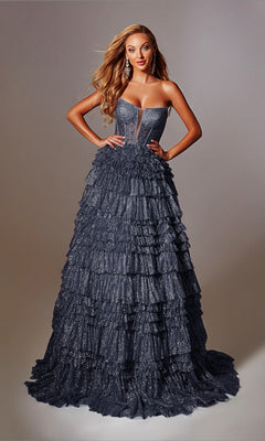 A woman poses with hands on hips in the Strapless Long Prom Ball Gown: Aerie Couture 276, a dark blue dress with tiered ruffles and glitter details, set against a plain background.