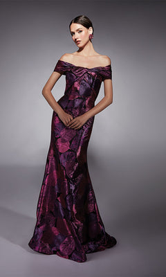 A woman in the Alyce 27702 long formal jacquard off-the-shoulder gown with purple and dark pink floral pattern, ideal for a mother of the bride, stands against a neutral gray background.