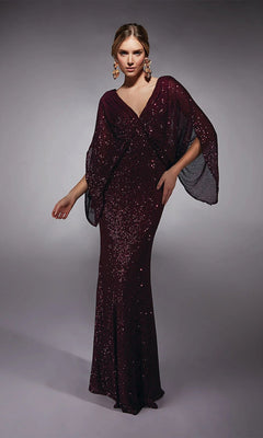A woman models the Alyce 27703 Long Formal Dress in aubergine, featuring floor-length sequins and wide draped sleeves. Paired with statement earrings, it's ideal as a mother-of-the-bride or formal evening gown against a gray backdrop.