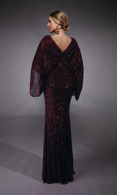 A woman stands with her back to the camera, showcasing the Alyce 27703— a floor-length, dark burgundy sequin gown with draped sleeves and a low back, perfect for mothers of the bride or any formal evening event.