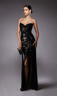 A woman in the Alyce 27704 long formal dress—strapless, sequin embellished with a sweetheart neckline and high slit—holds a black clutch while standing against a plain gray background.