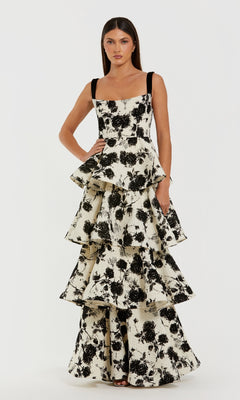 Woman wearing a black and white floral dress on a white background