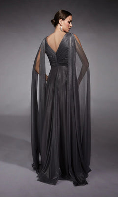 A woman stands against a gray background, facing away in the Alyce 27720—an elegant floor-length dark gray metallic chiffon gown with draped sheer cape sleeves, perfect for any mother-of-the-bride moment.