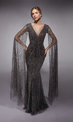 A woman in the Alyce 27725 long formal dress in charcoal, featuring intricate beading, a fitted sheath silhouette, and sheer cape-like sleeves, poses against a neutral background.
