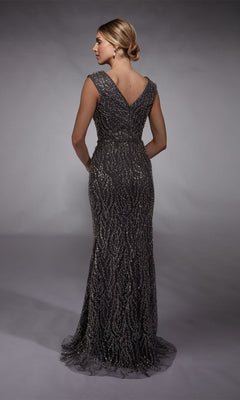 A woman stands facing away, wearing the Alyce 27725 long formal dress—a floor-length, sleeveless, dark gray fitted sheath with intricate sequin detailing.