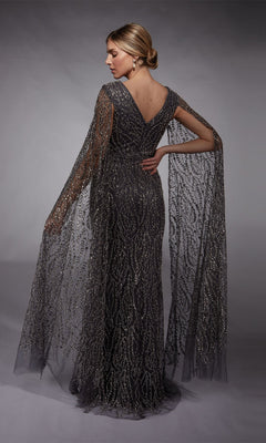 A woman faces away from the camera in the Alyce 27725 long formal dress, a fitted sheath gown with metallic details and draped sheer cape sleeves.