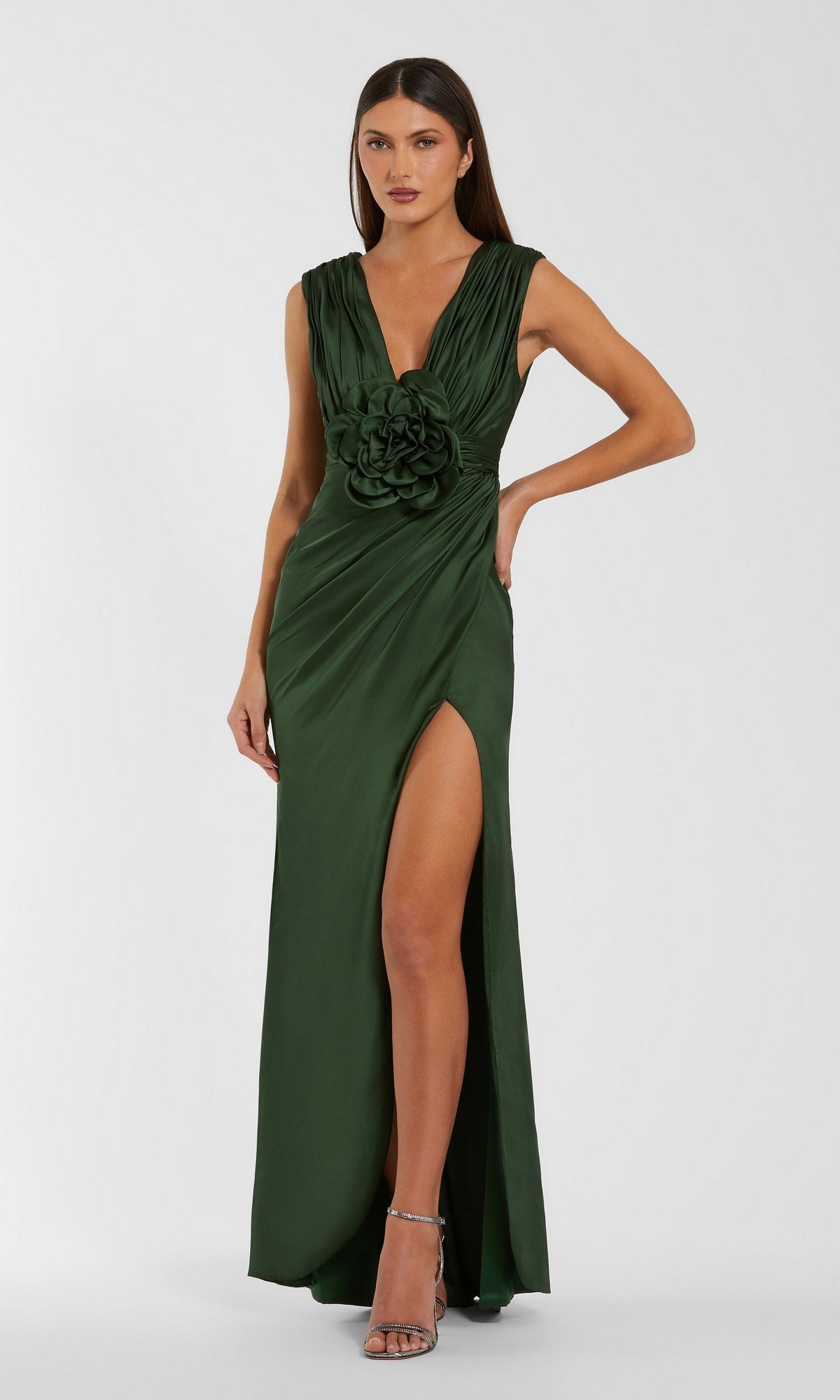 A woman wearing the Mac Duggal 27728 long formal dress in Pear—a sleeveless gown featuring 3D floral appliqué at the waist and a high leg slit—paired with strappy high-heeled sandals.