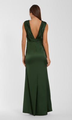 A woman stands with her back to the camera against a plain, light background, modeling the Long Formal Dress: Mac Duggal 27728—an elegant, olive green gown with a deep V-back. The sleeveless design is elevated by intricate 3D floral applique detailing, adding texture and sophistication to the overall silhouette.
