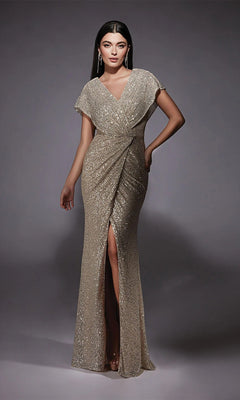 A woman wears the Alyce 27729 long formal dress in sand, featuring a floor-length design with short sleeves, V-neckline, wrap-style bodice, and front slit—an elegant choice for a mother-of-the-bride.