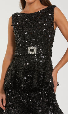 Black sequin dress with a white square design on a neutral background