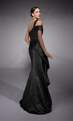 A woman models the Alyce 27734 long formal dress, an off-the-shoulder black gown with a textured pattern, standing against a plain gray background.