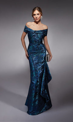 A woman poses against a plain background wearing the Alyce 27737: a blue jacquard off-the-shoulder long formal dress with a draped skirt, accessorized with a silver clutch and statement earrings.
