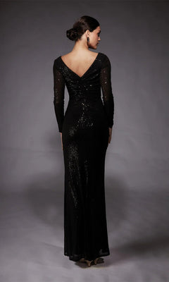 A woman faces away, wearing the Alyce 27741 long formal dress with a sequined design, deep V-back, and floor-length black sleeves, set against a neutral gray background.