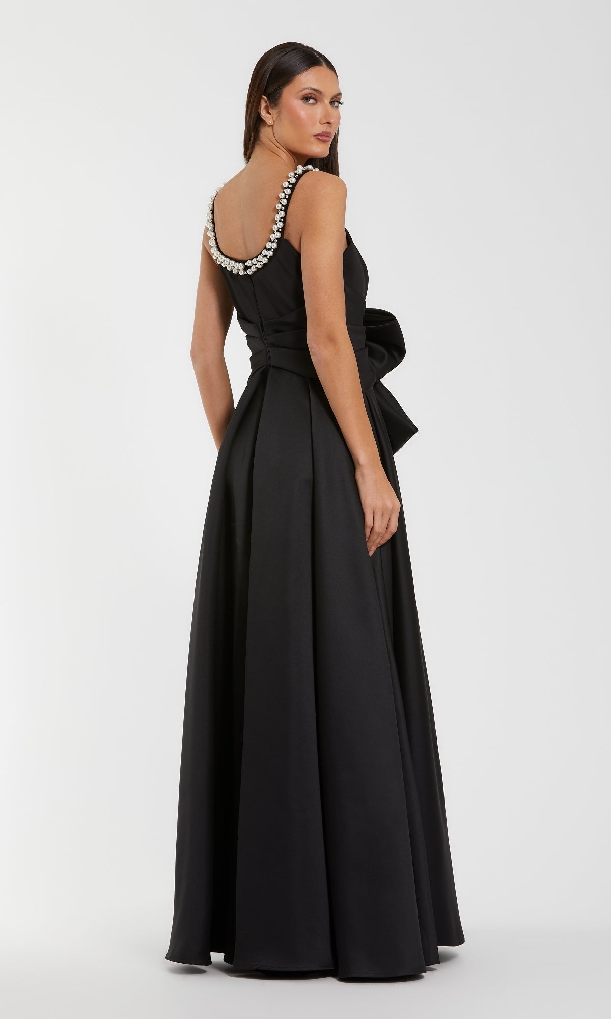 Black evening gown with beaded straps on a white background