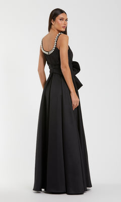 Black evening gown with beaded straps on a white background