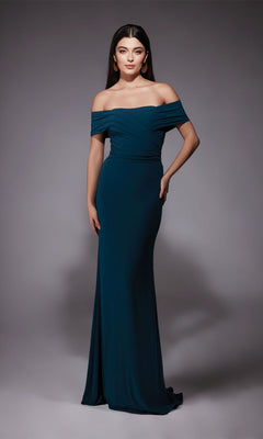 Wearing the Alyce 27745 long formal dress, a woman displays prom elegance in an off-the-shoulder, floor-length teal gown against a plain gray background.
