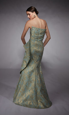 A woman in the Alyce 27750 long formal dress, featuring a strapless gold lace pattern, side drape, metallic jacquard brocade finish, and mermaid skirt, stands with her back to the camera against a neutral background.