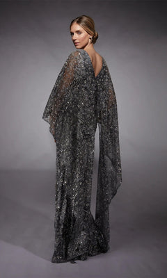 A woman faces away, wearing the Alyce 27752: a floor-length silver glitter tulle formal dress with sheer flowing sleeves, set against a gray backdrop.