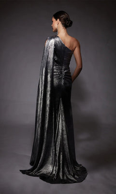 A woman stands with her back to the camera in the Alyce 27753 long formal dress, a one-shoulder metallic chiffon gown featuring a draped train, set against a dark background.