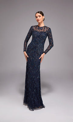 Wearing the Alyce 27778, a long navy blue beaded evening gown with sheer sleeves, this elegant look is a perfect choice for a mother of the bride against a simple gray background.