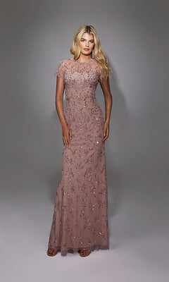A woman stands in a studio wearing the Alyce 27789, a long formal mauve sequin dress with short sleeves and sparkling floral embellishments.