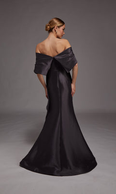 A woman with her hair in a low bun stands facing away from the camera against a gray background, wearing the Alyce 27822 Long Formal Dress—an off-the-shoulder, floor-length gown with a mermaid silhouette.
