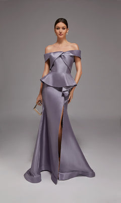 A woman poses against a plain gray background in the Alyce 27827 long formal dress—an off-shoulder, metallic lavender gown with a peplum waist and high slit—holding a small clutch.