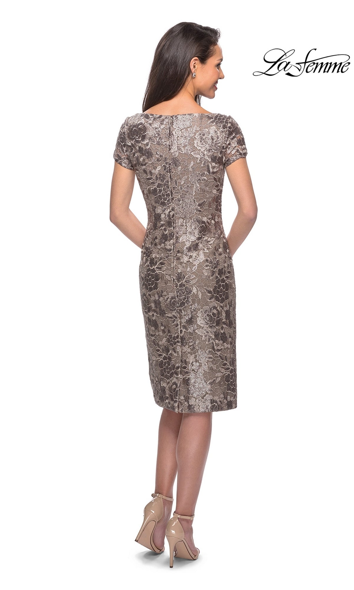 Back view of a woman wearing a Knee Length Wedding Guest Dress: La Femme 27828, featuring short lace sleeves and nude high-heeled sandals.