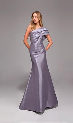 A woman in the Alyce 27838 long formal dress, a floor-length lilac satin gown with a one-shoulder design, stands with her hands behind her back against a plain gray background.