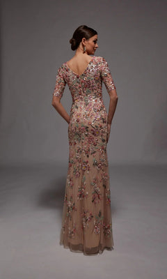 A woman faces away, modeling the Long Formal Dress: Alyce 27848—a fitted, floor-length nude gown with short sleeves and floral beaded appliques—perfect for formal occasions, set against a plain gray background.