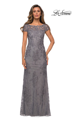 A woman wearing a dark platinum Long Formal Dress: La Femme 27856, a dark gray lace floor-length sheath with cap sleeves, floral embroidery, and a sheer neckline.