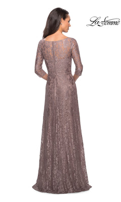 A woman seen from the back wearing a La Femme 27857 mauve, floor-length A-line lace formal dress with a high illusion neckline and three-quarter length sleeves.