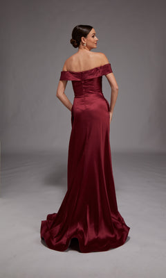 A woman faces away, wearing the Alyce 27857—an off-the-shoulder, floor-length burgundy satin formal dress with a slight train—posed against a plain gray background.