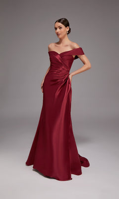 A woman wearing the Alyce 27857 long formal dress stands against a plain gray background with her hands at her sides.