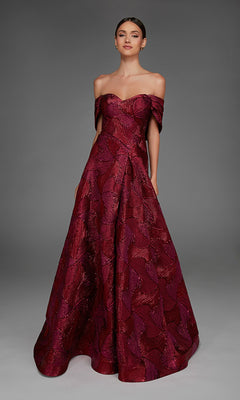 A woman wearing the Alyce 27884 Long Formal Dress in wine, featuring an off-the-shoulder design with a jacquard pattern and an elegant A-line skirt, stands gracefully against a neutral gray background.