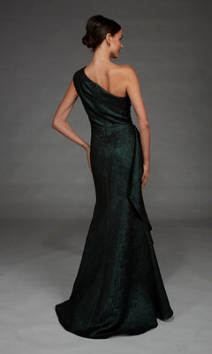 A woman stands with her back to the camera against a gray background, modeling the Alyce 27885 long formal dress in dark green, featuring a one-shoulder design.