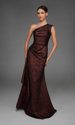A woman poses against a plain gray background wearing the Alyce 27885 long formal dress, a floor-length, one-shoulder evening gown in dark red with elegant draped detailing.