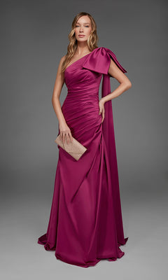 A woman in the Alyce 27891 long formal dress, featuring a cranberry, one-shoulder satin design, stands holding a beige clutch against a plain gray background.