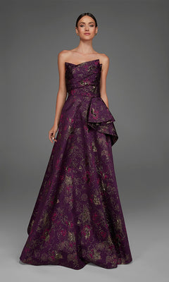 A woman wearing the Alyce 27893 long formal dress, featuring a stunning floor-length silhouette in purple with delicate floral jacquard patterns and a side bow, stands against a plain gray background.