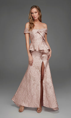 A woman wearing the Alyce 27899 long formal dress in French Pink, featuring textured fabric, an off-the-shoulder neckline, a peplum waist, and a front slit, stands against a plain gray background.