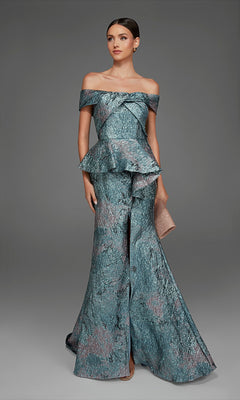 A woman poses in the Alyce 27899 long formal dress in verdigris, an off-the-shoulder gown featuring a peplum waist and a slit skirt, holding a textured clutch against a plain gray background.