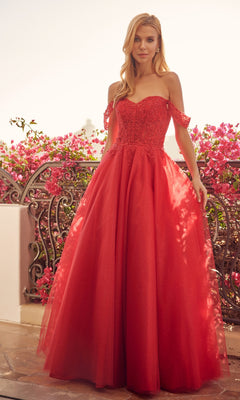 A woman stands on a balcony in the Lace-Up Off-Shoulder Long A-Line Prom Dress 280, featuring a lace corset bodice and flowing tulle skirt; pink flowers and ornate railing enhance the elegant setting.