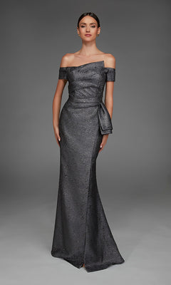 A woman wearing the Alyce 27900 Long Formal Dress in charcoal, featuring an elegant off-the-shoulder metallic jacquard design with a fitted bodice and side bow, stands against a plain gray background.