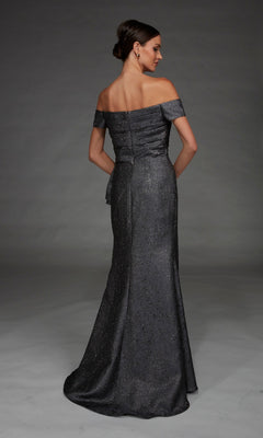 Clad in the Alyce 27900 Long Formal Dress, a woman stands with her back to the camera against a plain gray background, the off-the-shoulder metallic jacquard gown catching the light and shimmering elegantly all the way to the floor.