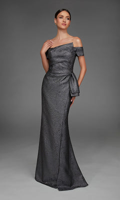 A woman wearing the Alyce 27900 long formal dress—a floor-length, off-the-shoulder metallic jacquard gown with a side bow—stands against a plain gray background.